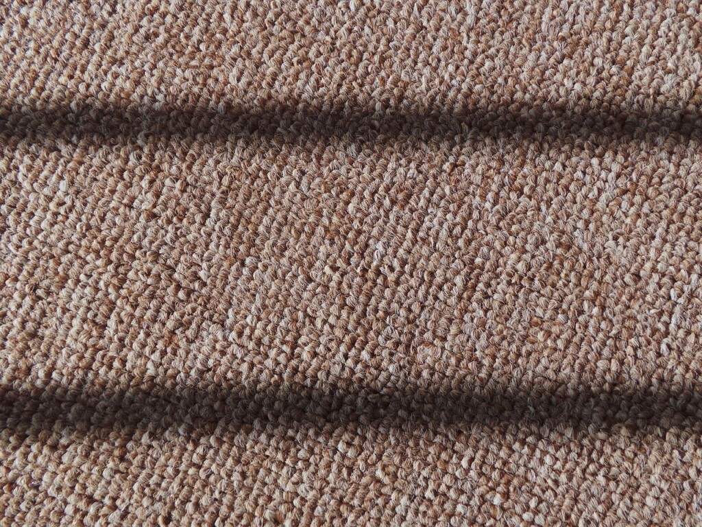 Berber carpet with tight loops and neutral colors, durable, comfortable, and low-maintenance for family homes