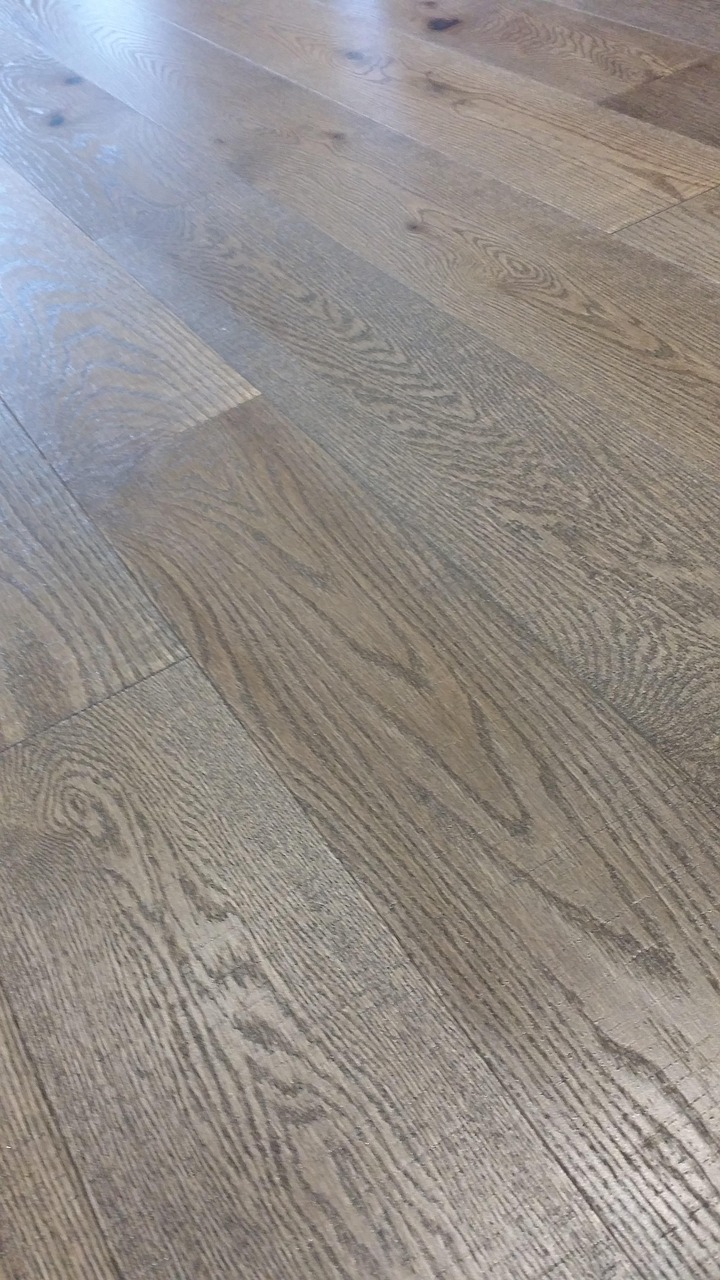 White Oak hardwood floor close-up highlighting the wood grain, natural texture, and light wood tones.